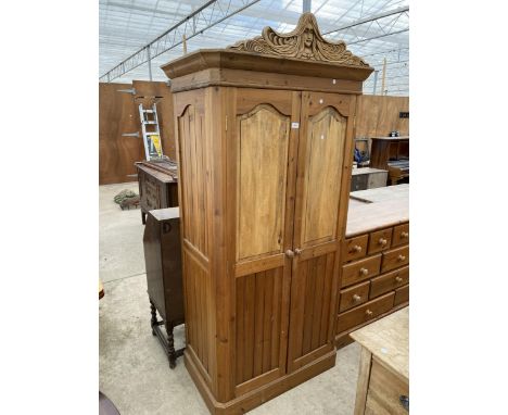 A MODERN PINE TWO DOOR WARDROBE WITH TWO INTERNAL PANELS HAVING NUDE CARVINGS, 39" WIDE 