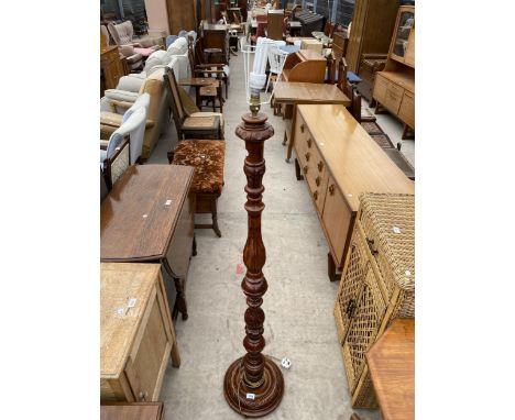 A HARDWOOD STANDARD LAMP ON TURNED COLUMN 