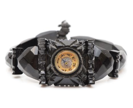 A Victorian Whitby Jet facetted bracelet, the central panel inset with a compass. 