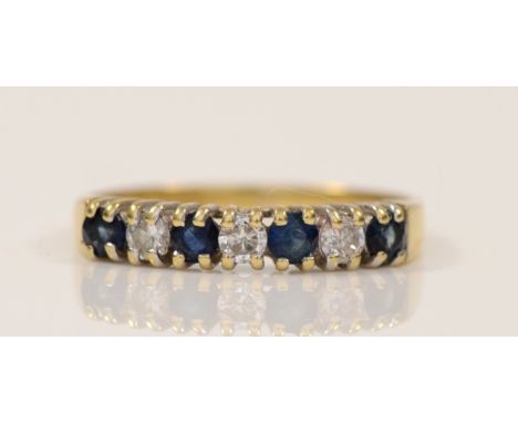 An 18ct gold sapphire and brilliant cut diamond seven stone ring, P, 2gm 