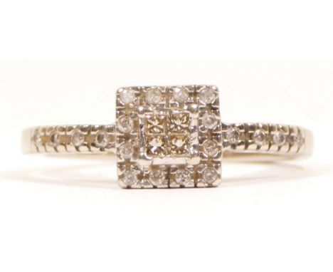 A 9ct white gold princess and brilliant cut diamond cluster ring, brilliants to the shoulders, W, 4.2gm 