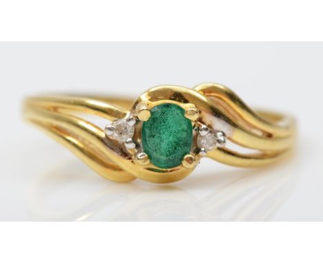 An 18k gold emerald and brilliant cut diamond dress ring, stamped 750, N, 2.3gm 