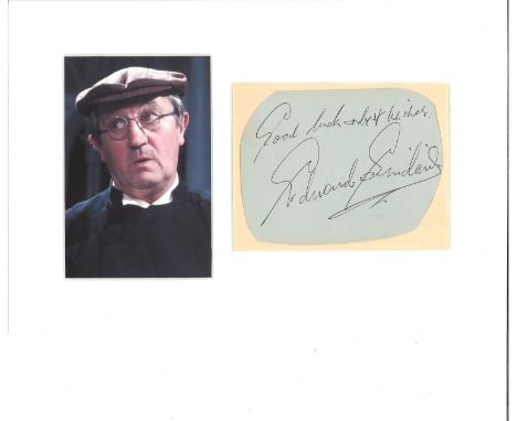Edward Sinclair signature piece mounted alongside colour photo as the Verger in Dads Army. Approx overall size 13x9. Good Con