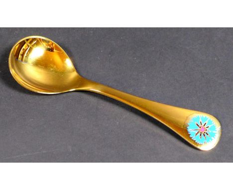A Georg Jensen gilt Sterling silver 1972 year spoon, with enamel corn marigold to its finial, Designed by Rigmor Anderson and
