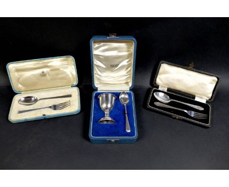 Three George V and later cased silver Christening sets, comprising an egg and cup set, both inscribed 'Susan', egg cup 5 by 7