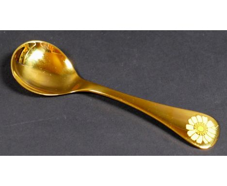 A Georg Jensen gilt Sterling silver 1973 year spoon, with enamel corn marigold to its finial, Designed by Rigmor Anderson and