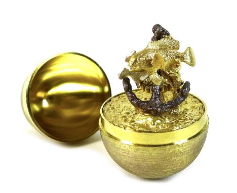 A Stuart Devlin silver gilt 'Surprise' egg, the outer chased surface with plain band to middle, opening to reveal an aquatic 