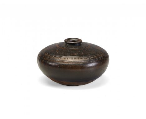 CERAMIC JAR  Khmer, 11th-12th Century Compressed globular body and small circular mouth, dark brown glaze with an incised dec