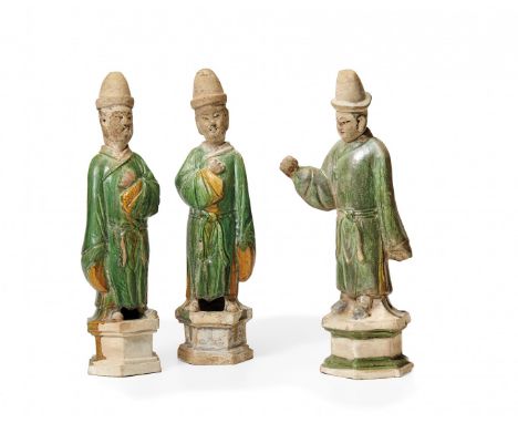 THREE CERAMIC FIGURES OF DIGNITARIES China, Ming dynasty Ceramic partially covered with breen and yellow glaze, each of the f