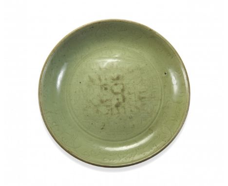 LONGQUAN CERAMIC LARGE DISH China, Ming dynasty, 14th-15th Century Circular section with ring base and rounded walls, incised