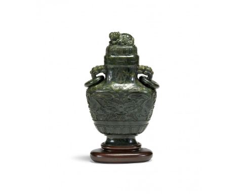 SPINACH GREEN JADE VASE WITH COVER China, 19th Century Oval section, handles shaped as a fantastic animal's head with a ring,