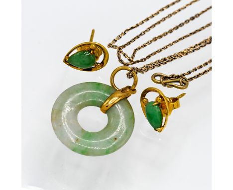 A twentieth century jade pendant set in a yellow metal mount on a fine chain, together with two jade and gold earrings marked