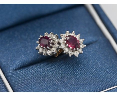 A pair of 18ct ruby and diamond cluster earrings.