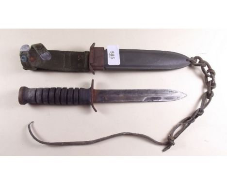 An American WWII fighting knife and scabbard