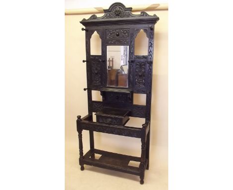 A Victorian carved oak hallstand with glove box and stick stands