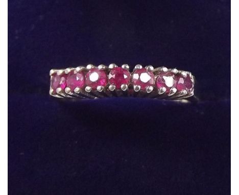 A 9 carat gold line set ruby ring, size M