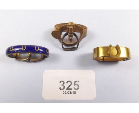 An enamel scarf clip with horseshoe decoration and stirrup form sprung clips and two other horse related scarf clips