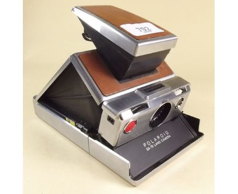 A Polaroid  SX - 70 land camera with instructions