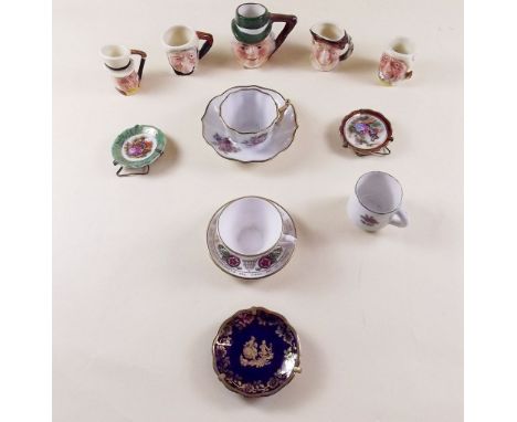 A collection of miniature tea cups and saucers including Spode, and a collection of Toby jugs
