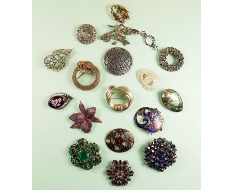 A box of vintage costume brooches