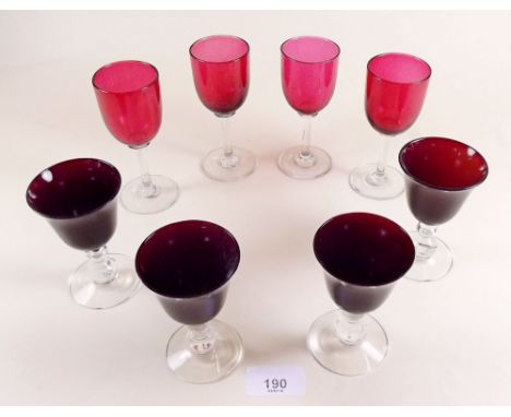 Four cranberry glass sherry glasses and four ruby glass ones