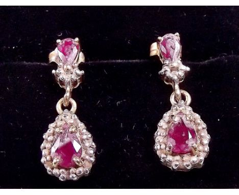A pair of 18k gold ruby drop earrings
