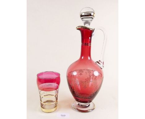 A etched cranberry glass decanter and a tumbler