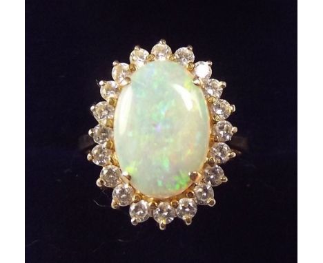 A 14k gold opal   ring  set white stones, size O