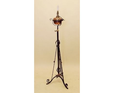A Victorian Art Nouveau cast iron standard oil lamp with copper reservoir and brass mounts