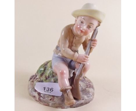 A Royal Worcester figure of a boy seated with a shot gun, impressed marks and registration mark, 13cm tall