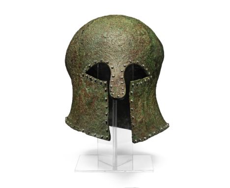 A Greek bronze Corinthian helmet with silver rivetsCirca 7th-6th Century B.C.24cm highFootnotes:Provenance:Kuizenga collectio