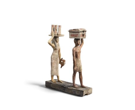 An Egyptian wood model of offering-bearersMiddle Kingdom, 12th Dynasty, circa 1976-1793 B.C.64.5cm high, 50.4cm wideFootnotes