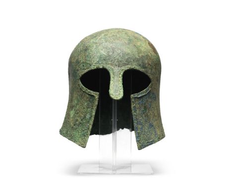 A Greek bronze Corinthian helmetCirca late 7th Century B.C.24cm highFootnotes:Provenance:Otto Heck collection, Bonlanden, Ger