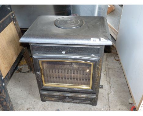 An "Arrow Becton" cast iron multi fuel stove having easy change wood/coal grate and riddle with air wash system, 22" high x 1