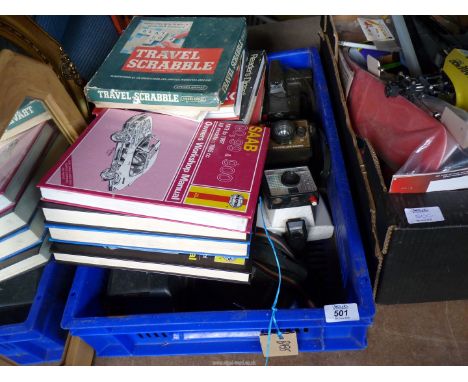 A box of Polaroid cameras, car manuals, etc.