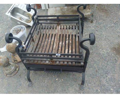 A very heavy cast-iron fire pit/Dog grate, 22" x 25" x 29" high.