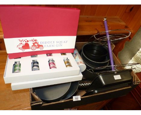 A box of kitchenalia including baking tins, a box of Diddly Squat Farm gin, etc.