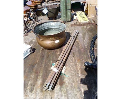 A quantity of brass carpet stair rods and a brass cooking pot.