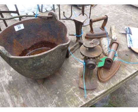 A quantity of cast iron items including irons, shoe last, pillar jack and a cooking pot.