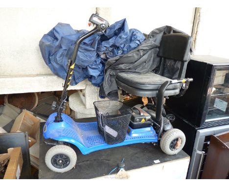A "Shop rider" Mobility Scooter with cover.