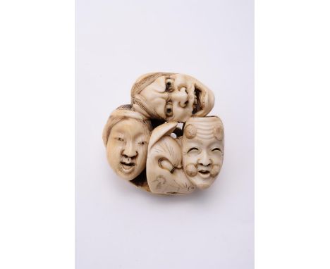 Y A Japanese Ivory Netsuke, carved in the form of a group of eight Kabuki and Noh masks, details etched in black, eyes inlaid