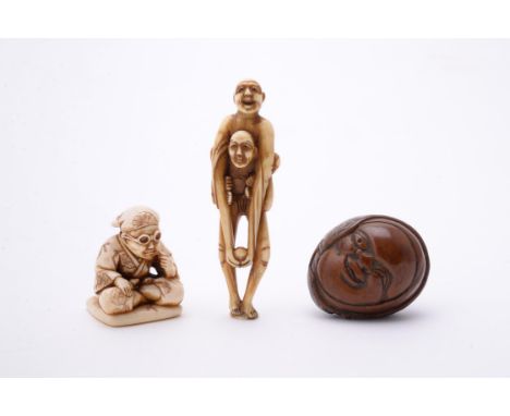 Y Gyokuzan: An Ivory Netsuke, carved as a kneeling figure wearing glasses and stoically pulling out his facial hair with twee