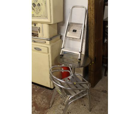 A METAL BISTRO TABLE WITH TWO CHAIRS AND A SMALL SET OF ALUMINIUM STEP LADDERS