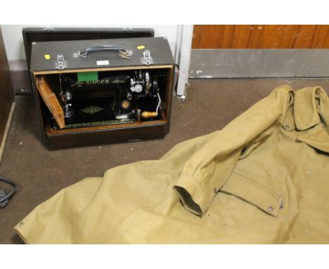 A CASED SINGER SEWING MACHINE TOGETHER WITH A VINTAGE MILITARY STYLE JACKET