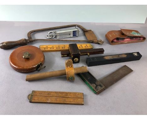 Vintage tools, to include wood markers, set square, surveyors tape, level, wooden folding rules, and 2 pocket balance  10 ite