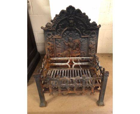 Cast Iron fire back and grate basket, the fire back with lions mask and ribbon decoration and depicting Don Quixote approxima