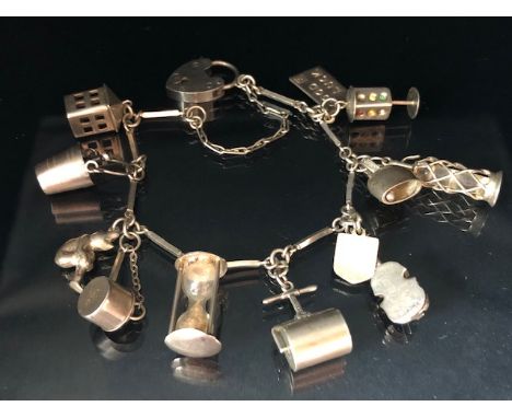 Silver 925 charm bracelet of elongated bar links with heart clasp and 12 charms to include a garden roller, hour glass ,Violi