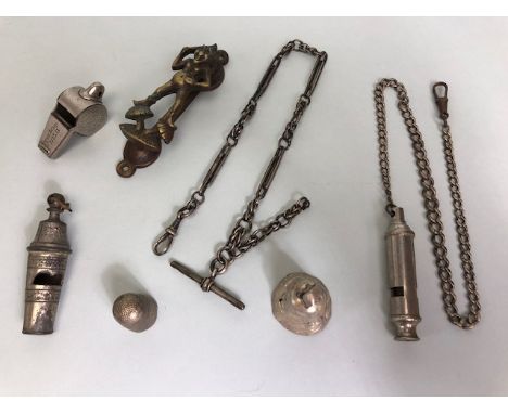 Collection of curios to include a silver hallmarked Albert and chain, railway interest whistles, an Exmoor Pixie door knocker