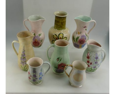 A good collection of Radford and E Radford jugs in foxglove, gloss daisy, Mother of Pearl, etc (8)