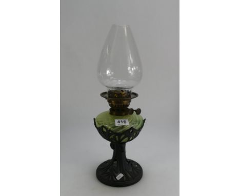 Vaseline twirled glass oil lamp with cast iron base in the art nouveau style with matching shade and chimney 